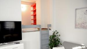 a living room with a tv and a desk at Work & Sleep in Piaseczno