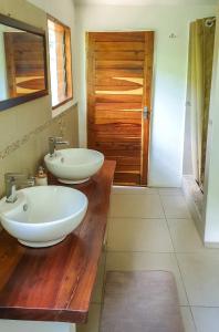 a bathroom with two sinks on a wooden counter at DOMUS - Private Bush Camp in Lusaka