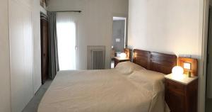 a bedroom with a bed and a mirror and a window at IL NIDO - By the sea - AC in Monterosso al Mare