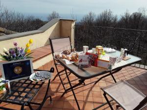 a table with food on top of a balcony at Antica Dimora Benanti in Milo