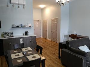 a living room with a table and a couch at Canalside Restaurant & Inn in Port Colborne
