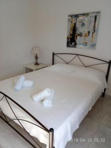 a bedroom with a bed with two towels on it at Cozy Apartment With Side View of Acropolis in Athens