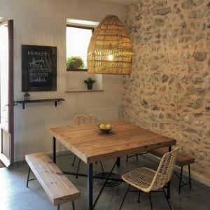 a dining room with a wooden table and chairs at Vista de la Vila - Turismo de interior. in Llubí +39 photos