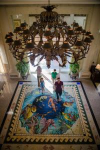 a group of people walking on a large rug in a building at The Lago Mar Beach Resort and Club in Fort Lauderdale