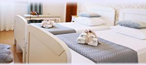two beds with towels on them in a room at Villa Šolo in Ploče
