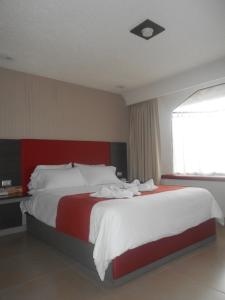 Postel nebo postele na pokoji v ubytování Hotel Puente Real