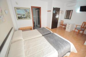 a bedroom with a large bed in a room at Hotel Goya in Almuñécar