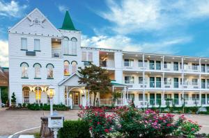 a large white building with flowers in front of it at Quality Inn Eureka Springs South in Eureka Springs