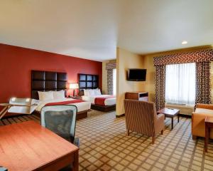 a hotel room with two beds and a couch at Comfort Inn & Suites Fort Smith I-540 in Fort Smith