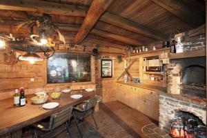 a kitchen with a table and a fireplace at Haus Erbhof in Sölden