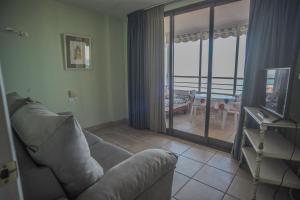 a living room with a couch and a balcony at Nereo II in Alicante