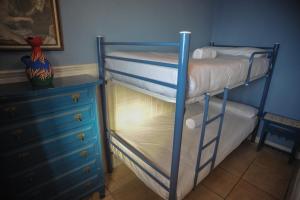 two bunk beds in a room with a dresser at Nereo II in Alicante