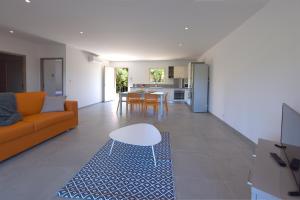 a living room with a couch and a table at SARL valinco locations in Olmeto