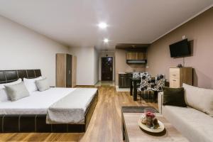 a bedroom with a bed and a living room at Family Hotel Ring & Thermal in Kyustendil