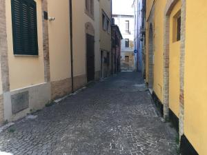an alley in an old town with a cobblestone street at La Casetta in Teramo