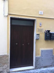 a brown door on the side of a building at La Casetta in Teramo