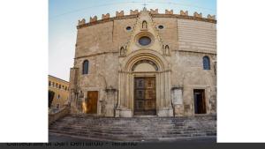 an old stone church with steps in front of it at La Casetta in Teramo