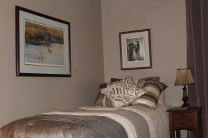 um quarto com uma cama e duas fotografias na parede em Tailwinds B&B em Erin