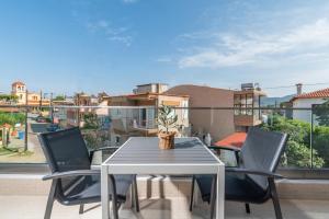 a table and chairs on a balcony with a view at Oasis in Sarti