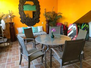 a dining room with a table and chairs and a mirror at Casa Juanita in Sayulita