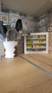 a kitchen with a cabinet filled with utensils at Tsiboulas Cretan Cottage in Kritsa