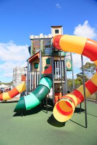 a playground with a slide in a park at Ingenia Holidays Ulladulla in Ulladulla
