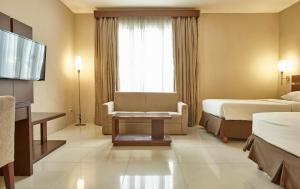 Posteľ alebo postele v izbe v ubytovaní Triniti Hotel Jakarta