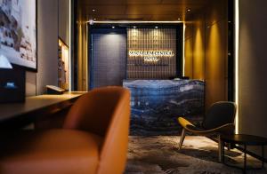 a waiting room with a chair and a window at Macallum Central Hotel Managed by The Ascott Limited in George Town +19 photos