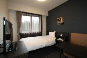 Ένα ή περισσότερα κρεβάτια σε δωμάτιο στο Hotel Route Inn Kesennuma Chuo Inter