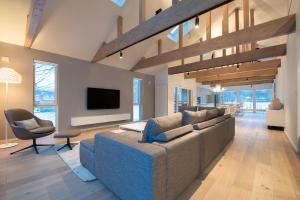 a large living room with a couch and a tv at Yotei Yama House in Niseko