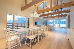 a kitchen and dining room with a table and chairs at Yotei Yama House in Niseko