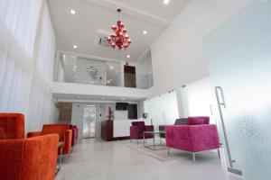 a room with red chairs and a table and a chandelier at The Park Slope Hotel in Bangalore