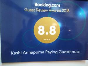 a sign for the guest review awards for kishi armumpump playing guesthouse at Kashi Annapurna Guest House in Varanasi