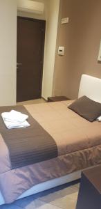 Posteľ alebo postele v izbe v ubytovaní Mia Suites