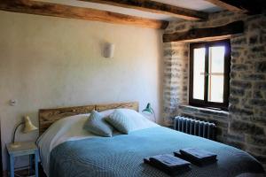 a bedroom with a bed with two towels on it at Bolara 60: the Cottage in Grožnjan