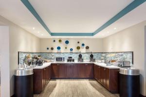 a large kitchen with wooden cabinets and a counter top at Quality Inn Gulfport I-10 in Gulfport