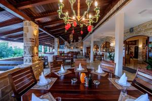 a restaurant with a table and chairs and a chandelier at Hotel Skalinada in Zavala