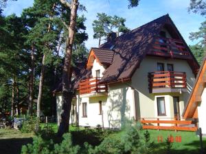 a house with a gambrel roof at Kama Pobierowo in Pobierowo