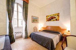 Postel nebo postele na pokoji v ubytování Hotel Giotto Flavia