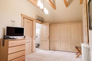 a living room with a television and wooden cabinets at Lacul Verde Resort in Ploieşti