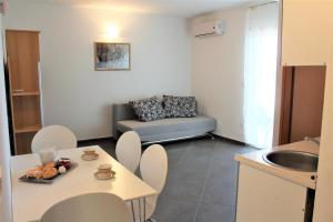 a small living room with a couch and a table at Apartmani Marija in Duće