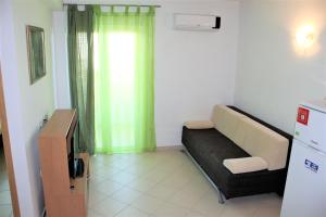 a living room with a couch and a window at Apartmani Marija in Duće +30 photos