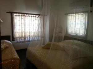 Postel nebo postele na pokoji v ubytování Villa Perla Hotel