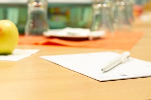 a pen sitting on top of a paper on a table at Quick Hotel Dresden West in Kesselsdorf