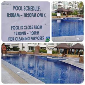 a large swimming pool with a sign next to it at F-10C Parkside Villas in Manila