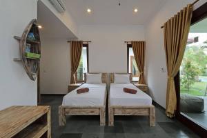 a bedroom with a bed and a large window at Bali Mynah Villas Resort in Jimbaran +63 photos