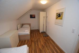 an attic room with a bed and a closet at Apartment Ostfildern-Nellingen II in Ostfildern