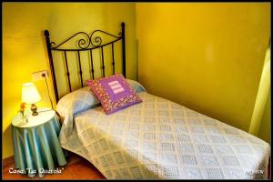 a bedroom with a bed with a pillow and a lamp at Casa La Querola in Morella