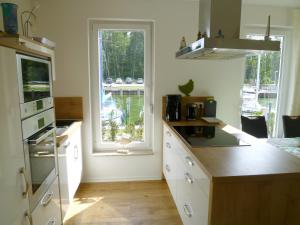 a kitchen with a counter and a window in it at Kapitänsresidenz - Haus direkt am Wasser in Ueckeritz