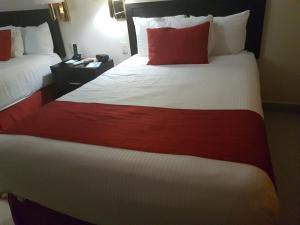 Postel nebo postele na pokoji v ubytování Hotel Real Colonial